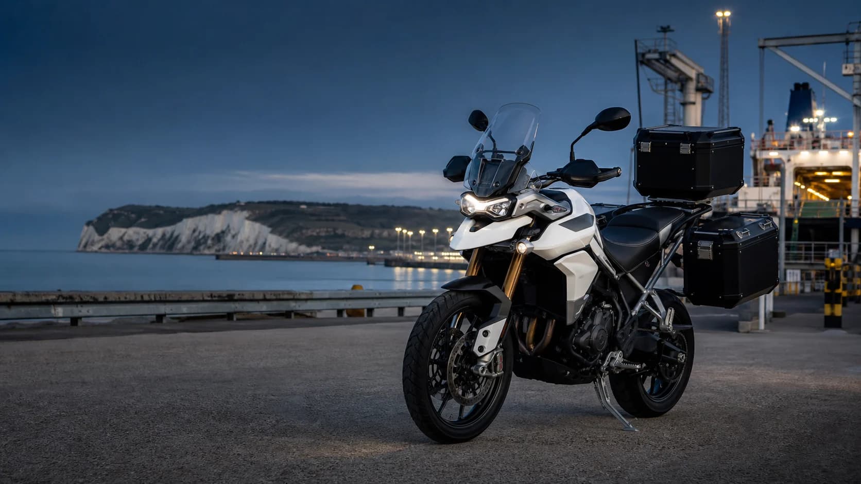 White courier motorcycle with secure luggage at Dover harbour
